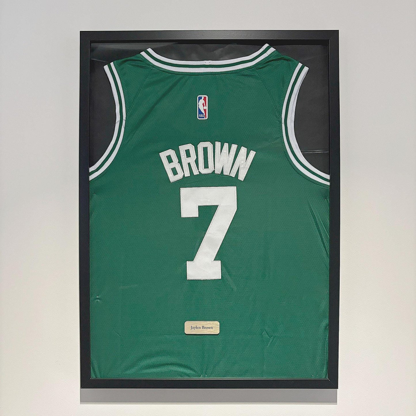 a basketball jersey hanging on a wall