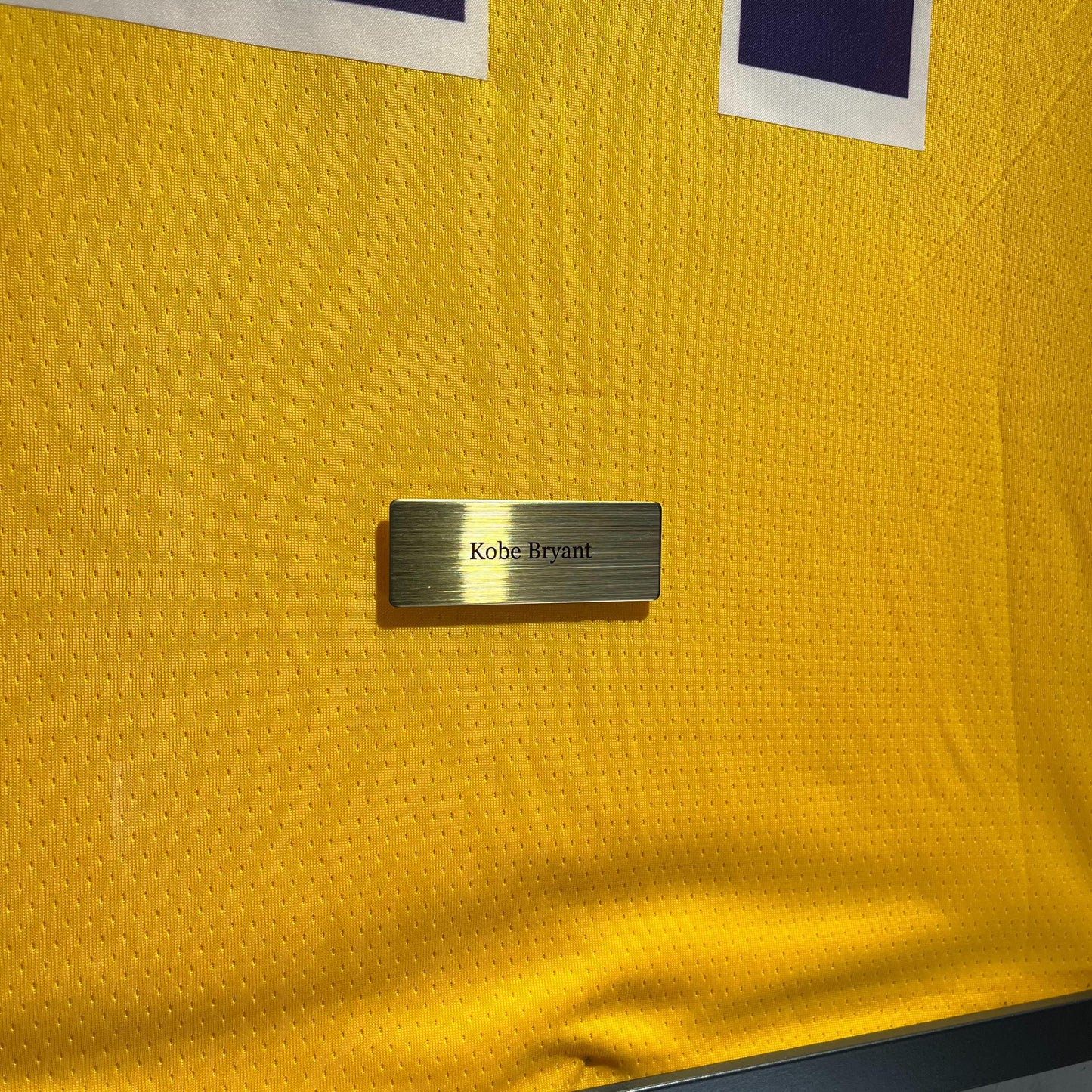 a close up of a cell phone laying on a yellow jersey