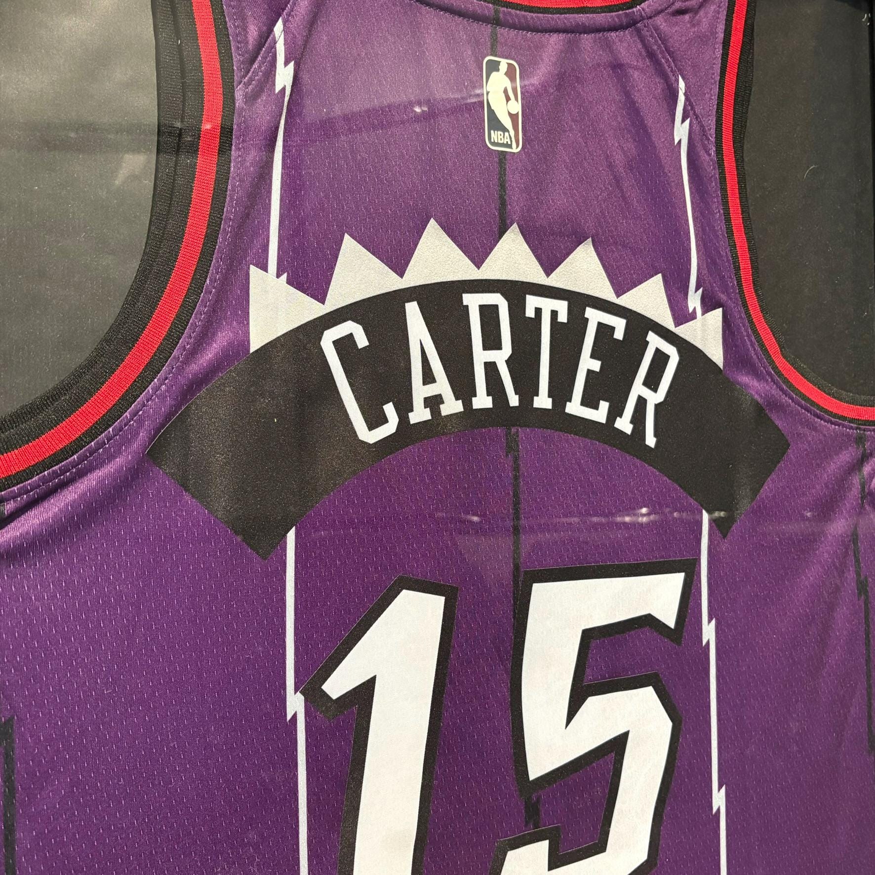 a purple basketball jersey with the number fifteen on it