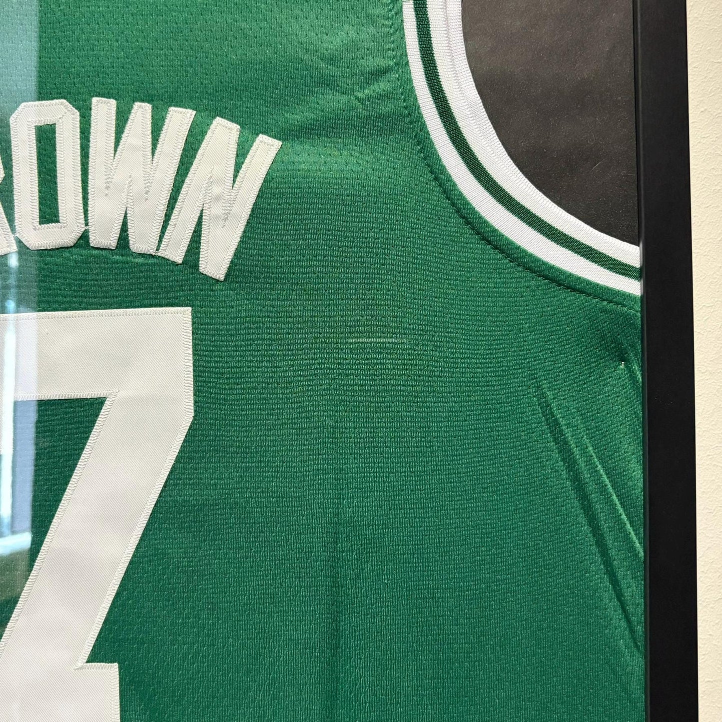 a green jersey with the number seven on it