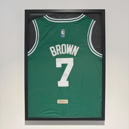 a basketball jersey hanging on a wall