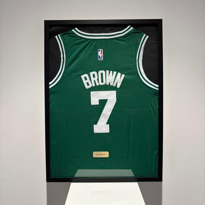 a basketball jersey is hanging on a wall